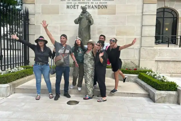 “Group photo of previous clients in front of Moët & Chandon cellars on a champagne day trip from Paris