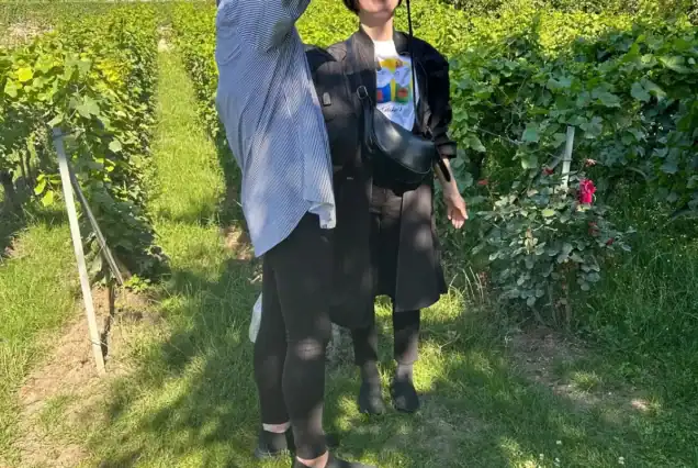 Couple enjoying scenic vineyard walk on a champagne day trip from Paris