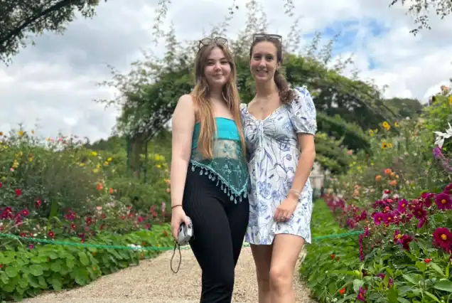 Private tour group walking through the flower-lined paths of Giverny Monet’s Gardens