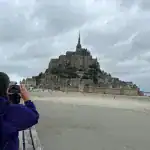 Approach to Mont Saint Michel across causeway on day trip from Paris