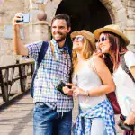 Couple with tour guide enjoying Mont Saint Michel day trip from Paris