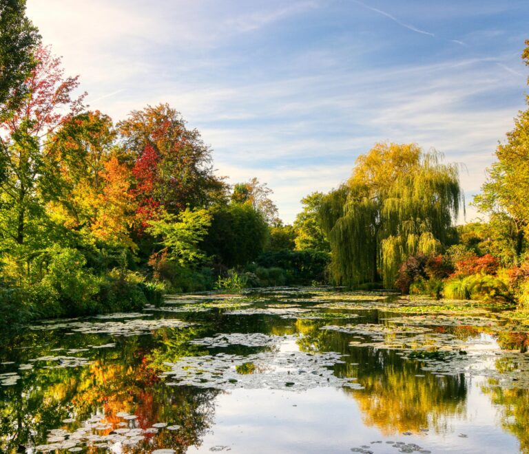 “Monet’s Garden in Giverny with the iconic Japanese bridge and vibrant summer flowers – a must-see day trip from Paris