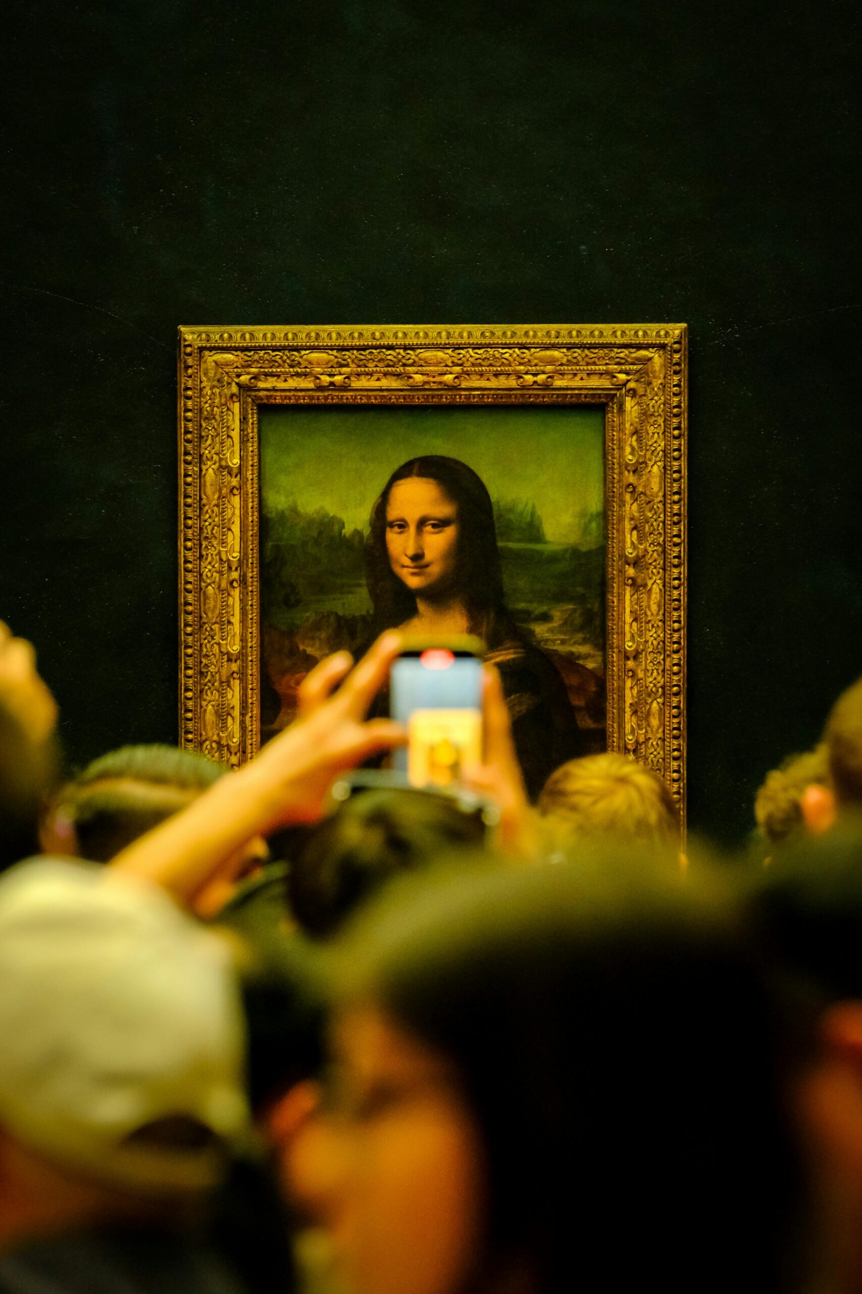 The Mona Lisa painting displayed in the Louvre Museum in Paris